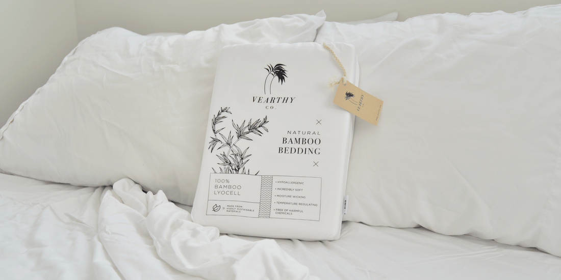 Crisp white vearthy bedding sits on a cozy bed with white bedding