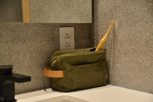 Canada's best electric toothbrush sits in a green cloth traveling case on a stone bathroom countertop | Vearthy