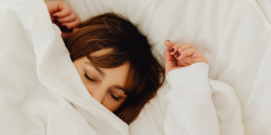 Girl in white bed with covers over face is sleepmaxxing at vearthy.com