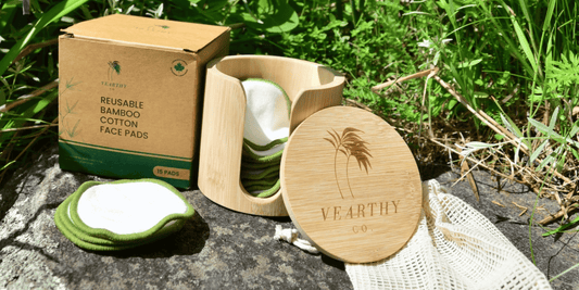 Ultra soft bamboo cotton facepads from Vearthy sit on display on a rock in the sun in front of some outdoor foliage 