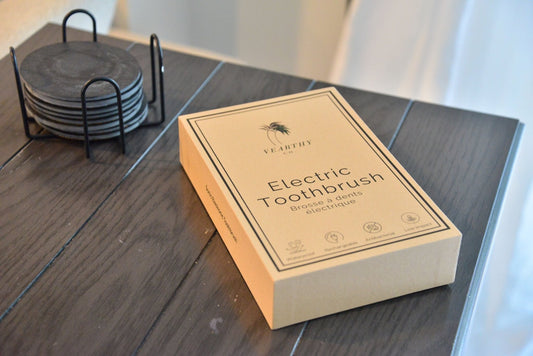 Vearthy bamboo sonic electric toothbrush sits on a brown table 