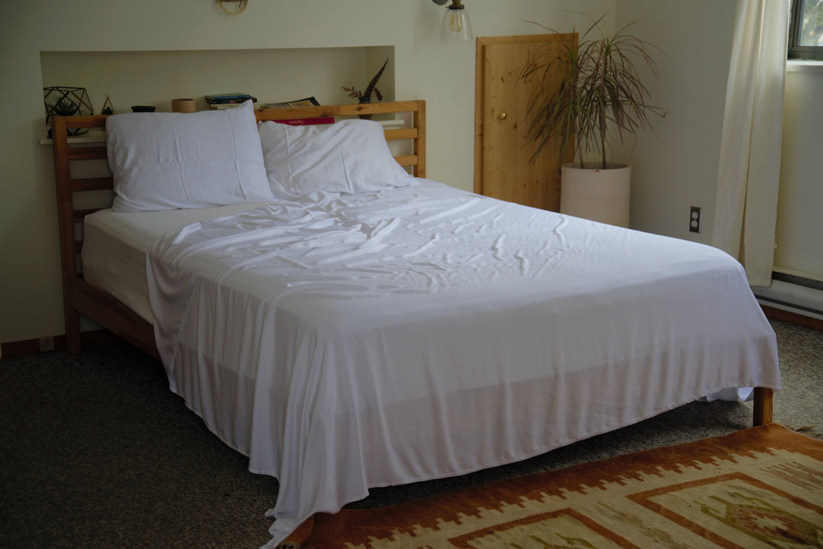 Vearthy bamboo lyocell bedding draped over a bed. It looks lightweight, cool to the touch and extremely soft.
