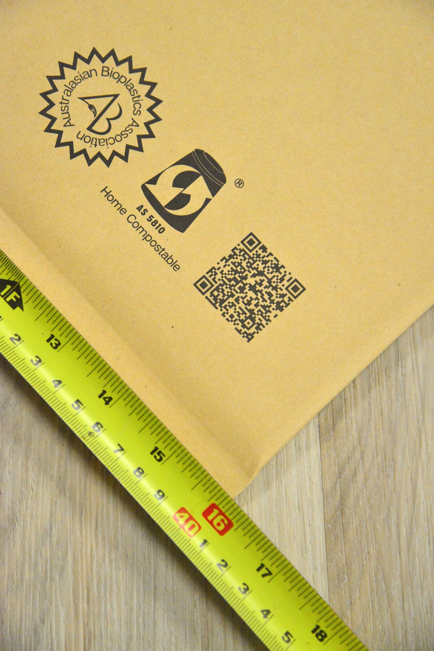 A measuring tape showing the Vearthy Compostable Mailer is 16"