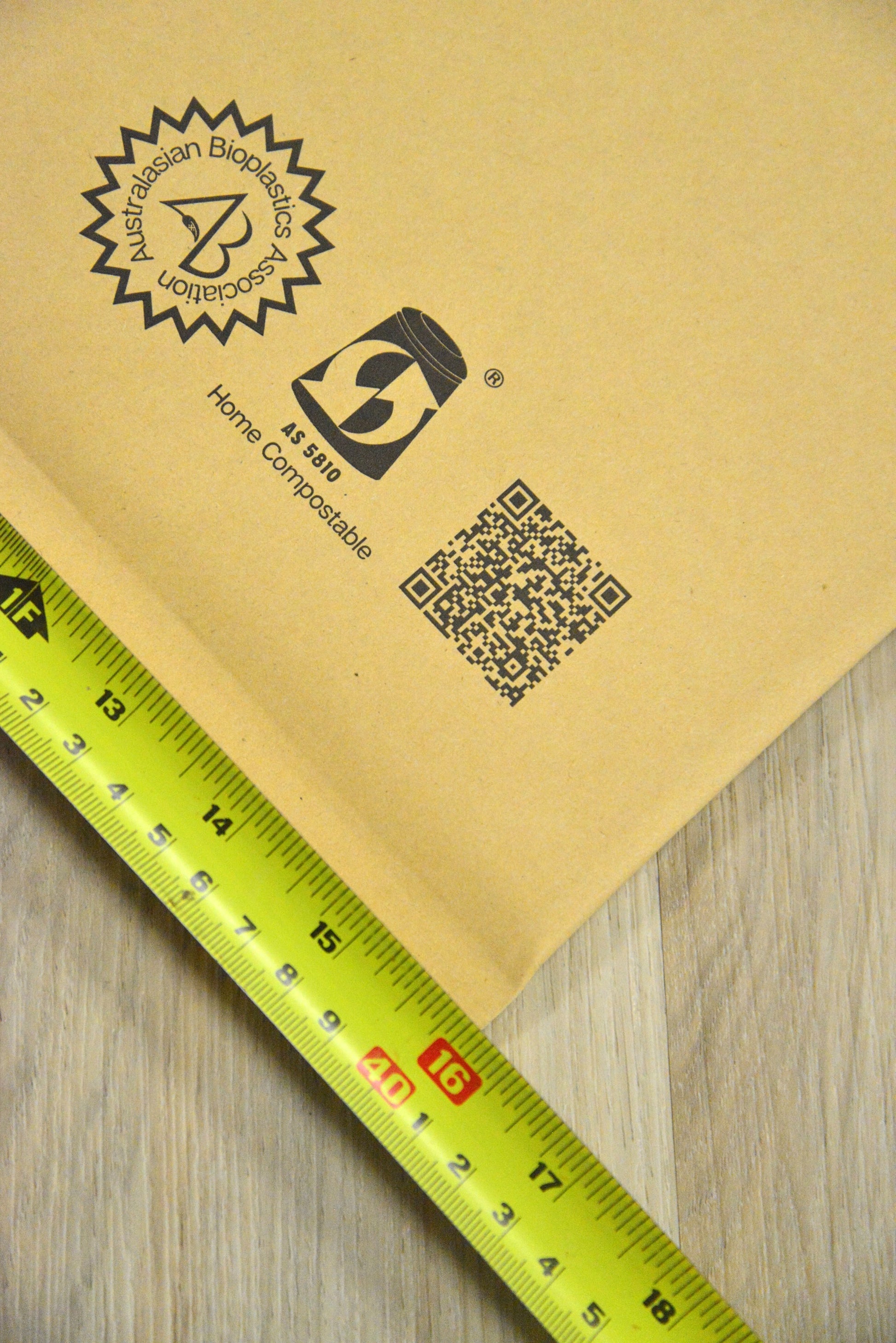 A measuring tape showing the Vearthy Compostable Mailer is 16"