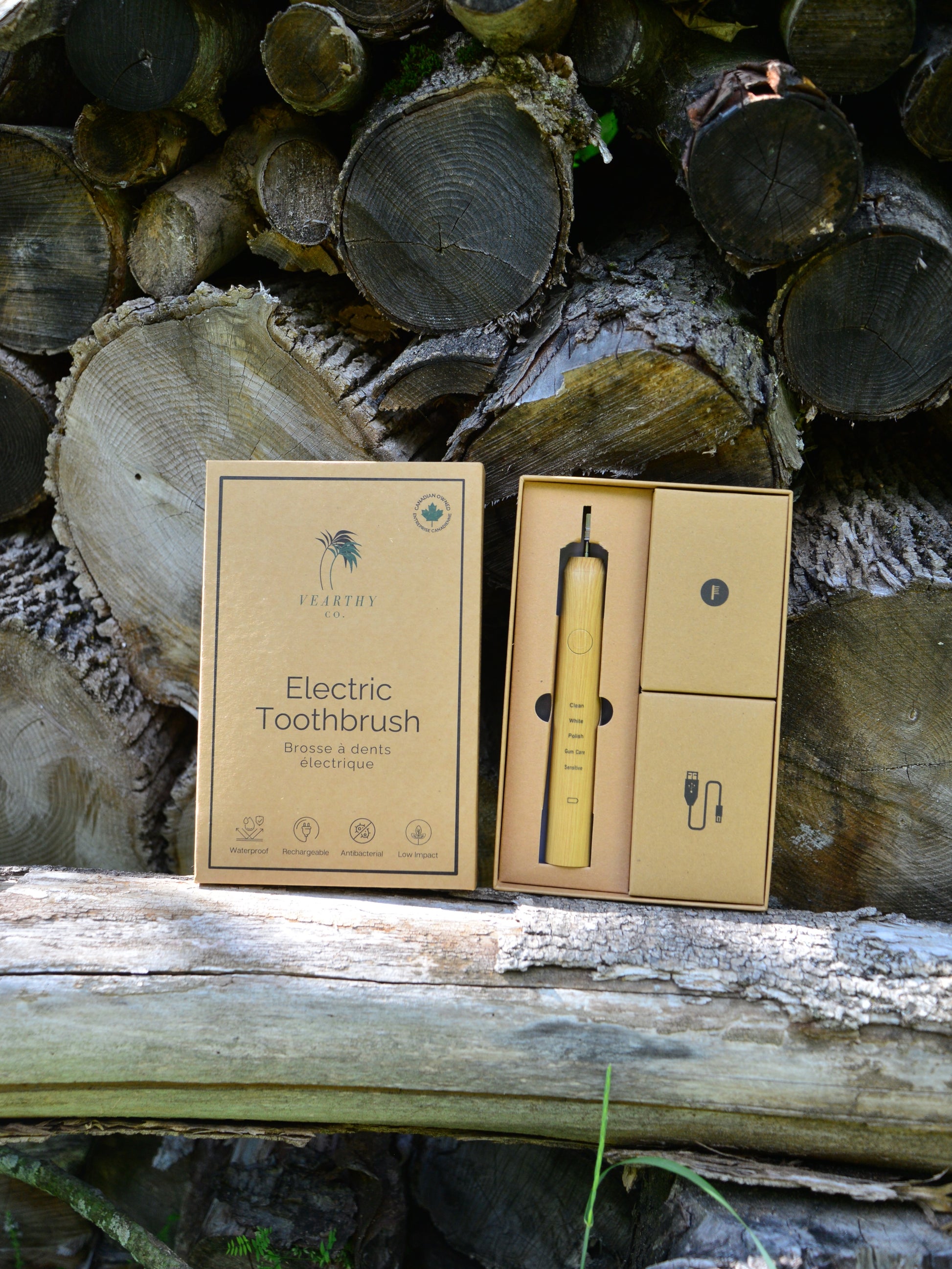 Vearthy bamboo sonic electric toothbrush sits on a log vearthy.com