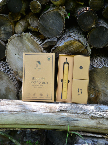 Vearthy bamboo sonic electric toothbrush sits on a log vearthy.com