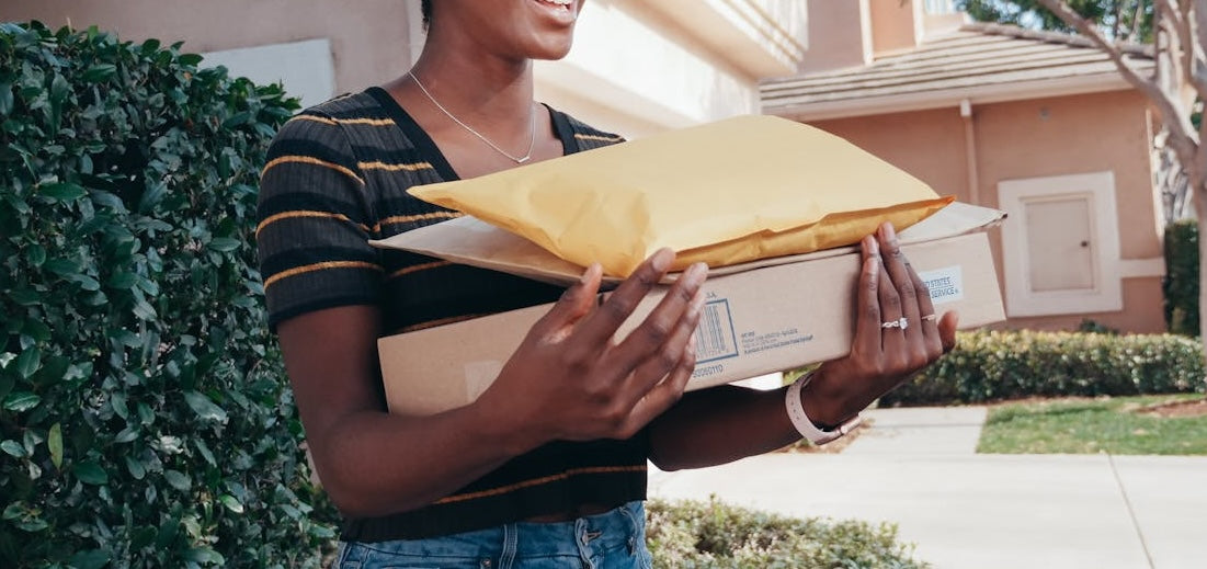 woman holding shipping packages vearthy.com