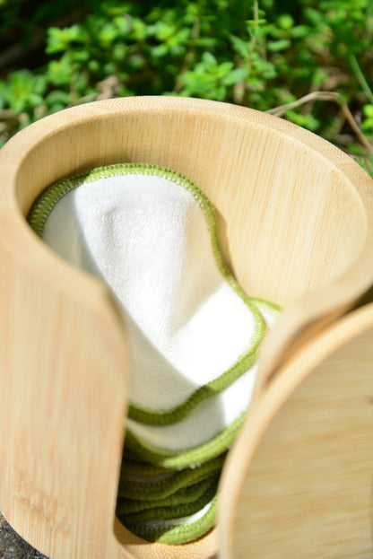 Close up of vearthy bamboo cotton face pads, showing texture of fibres and holding case.
