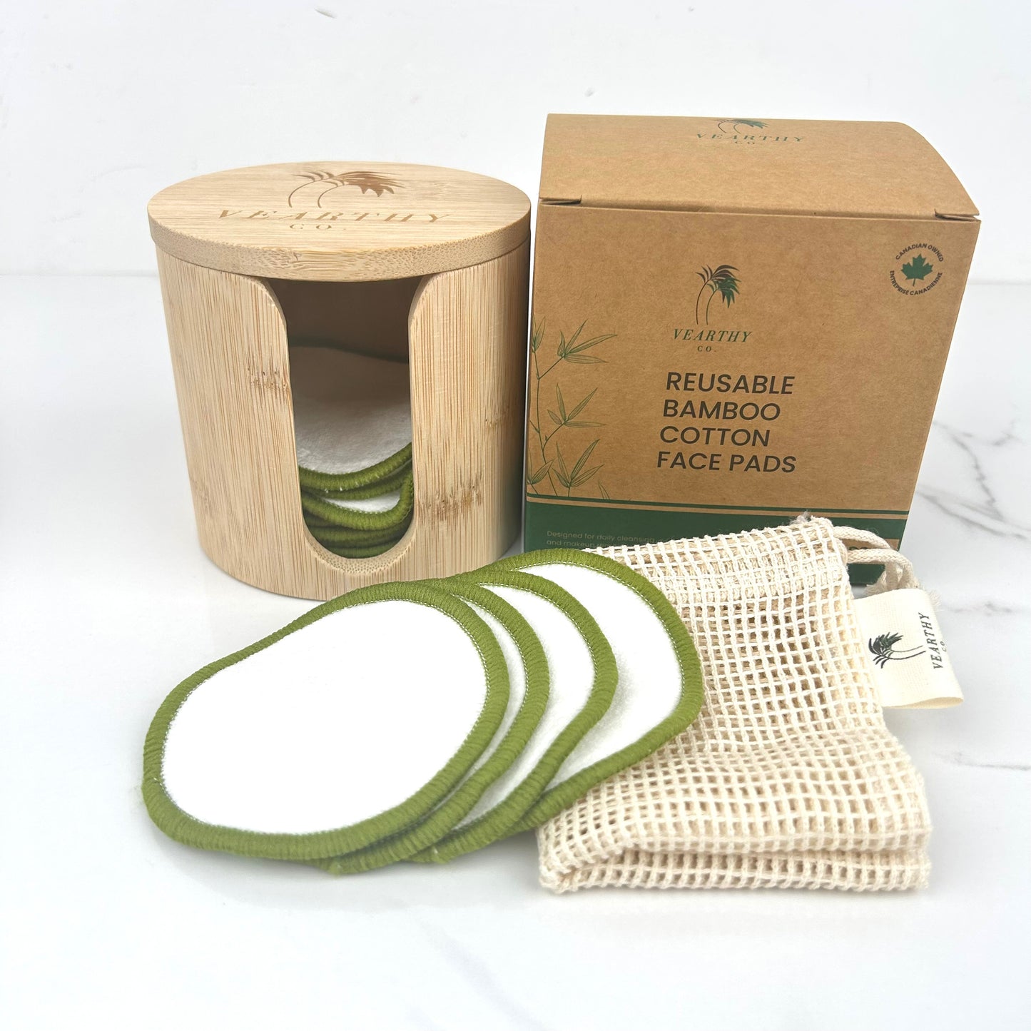 Reusable bamboo cotton face pads with bamboo container, cardboard box, and mesh bag on a white background
