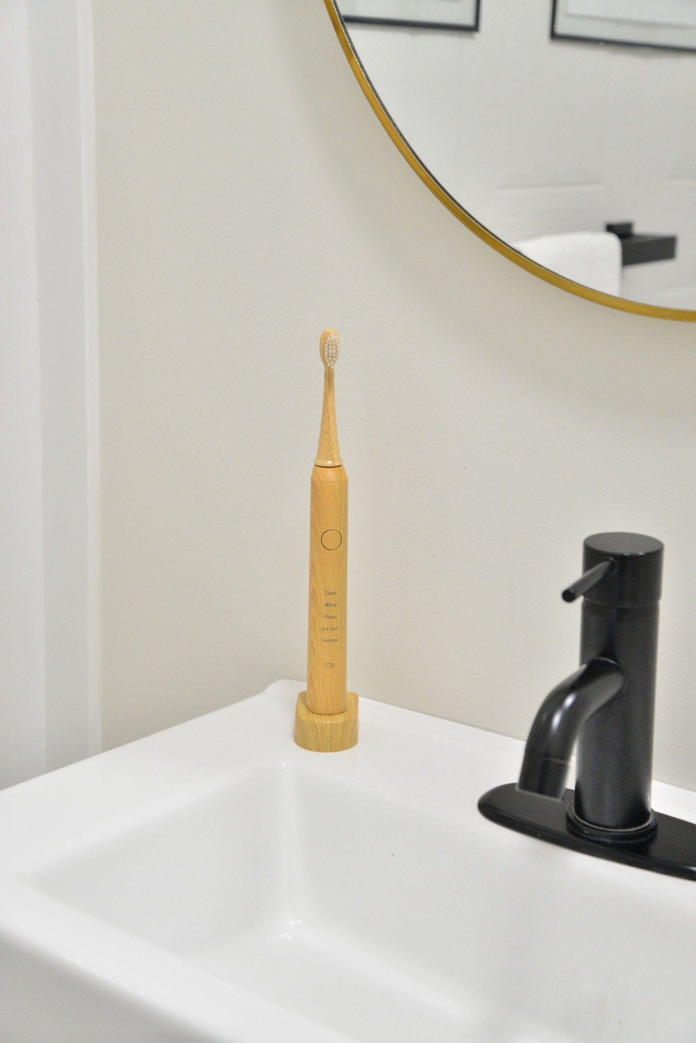Bamboo electric toothbrush displayed in modern bathroom
